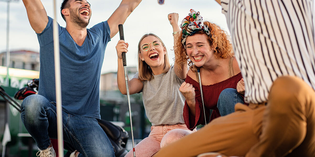 a group of people go mini golfing as part of sober activities in salt lake city