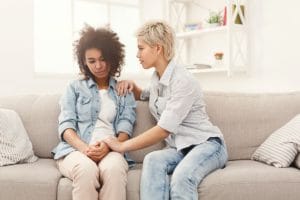 a woman talking to friend about seeking utah addiction treatment center programs 