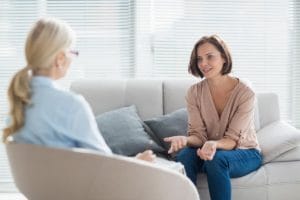 women talking while sitting on furniture, benzodiazepine addiction treatment program in UT