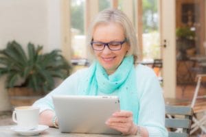 senior woman using tablet for telehealth program UT