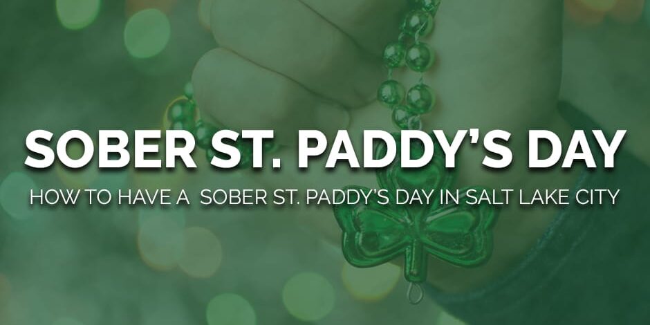 a person holds a shamrock and considers how to have a sober st paddys day in salt lake city