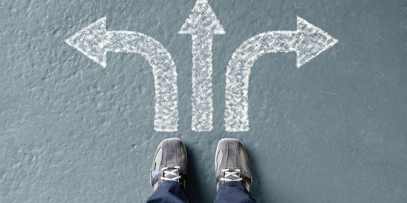 a man looks at directional signs for finding the right level of care in addiction treatment