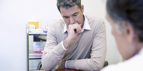 ery5 A man talks to his doctor about the difference between medication assisted treatment and drug replacement therapy