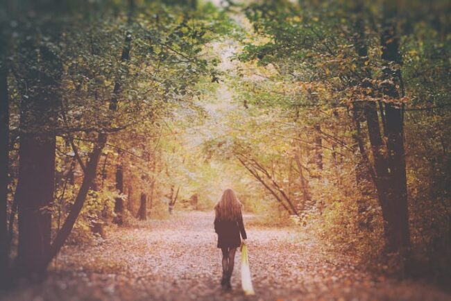 a woman takes a walk and wonders how mindfulness can help manage triggers
