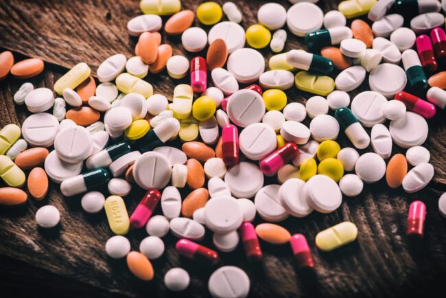 piles of pills represent the dangers of prescribing millennials prescription drugs