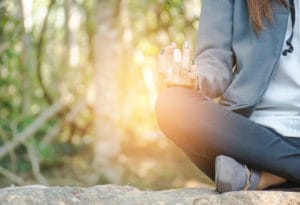 a woman practices mindfulness and meditation