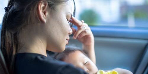 A woman holds her newborn daughter, and wonders how to stay sober as a new mom