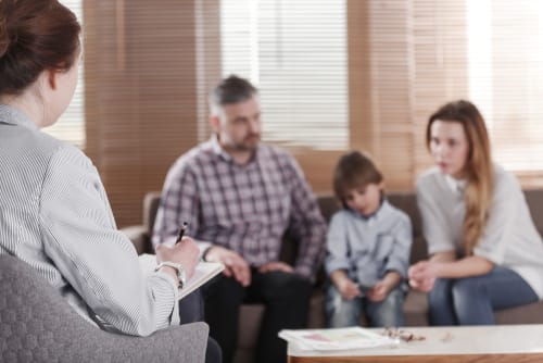 a therapist talks to a family about why family therapy is so important for addiction recovery