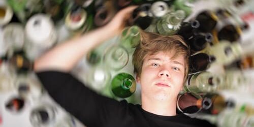 a boy is surrounded by bottles and wonders can you overdose on alcohol