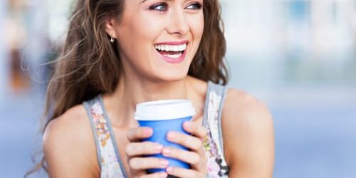 shutterstock_149679491 a woman holds a cup of coffee and thinks about self worth insecurity and addiction