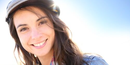 a woman smiles though she remembers reasons women relapse after addiction treatment