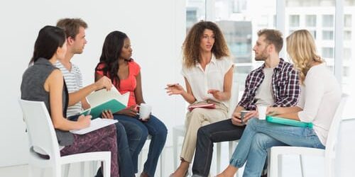 shutterstock_185899805 a group of people talk about entering treatment