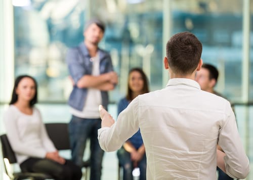 A man talks to a support group about whether or not you should share your addiction history