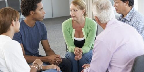 a group of people talk about the symptoms of ocd