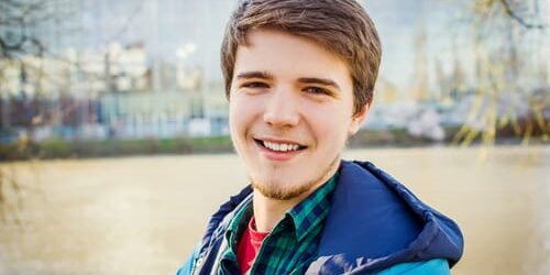 a young man smiles as he wonders whats the difference between cbt and dbt