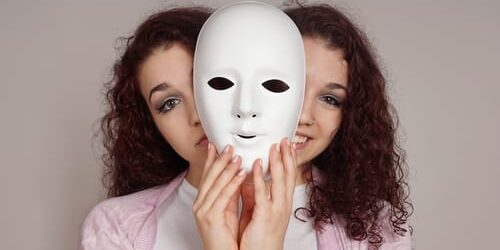 a woman hides behind a white mask and thinks about 5 myths about bipolar disorder