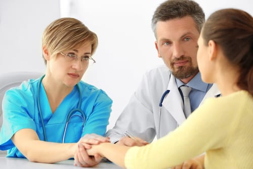 two doctors talk to a woman about considering medical detox