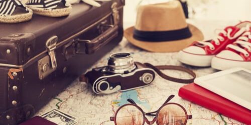 an unpacked suitcase begs the question how to stay sober while traveling