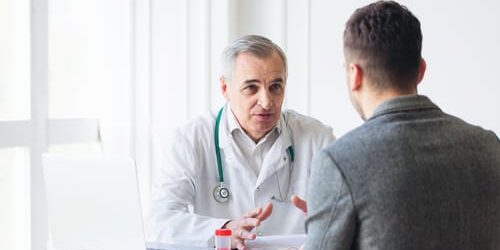 shutterstock_430385620 a doctor talks to his patient about the long term effects of opioid painkillers