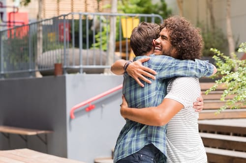 shutterstock_492562768 a man hugs his friend and thinks about how kindness can help you beat depression