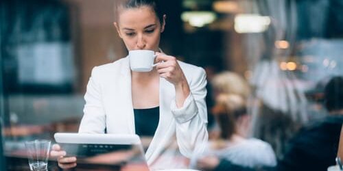 a woman drinks coffee and wonders is addiction a learning disorder