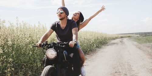 a man and woman ride a motorcycle and talk about learning self empowerment
