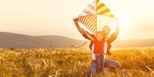 a man plays with his child and wonders will you pass addiction on to your children