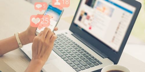 shutterstock_722600041 A woman researches whether there is a link between social media and depression on her smart phone