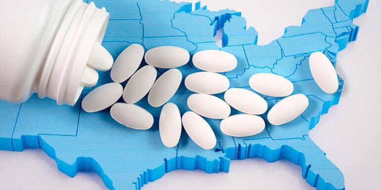 shutterstock_745206598 A pile of pills rests atop an image of the United States, showing the evolution of the opioid crisis