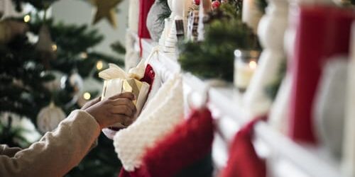 a person pulls a gift from a stocking and thinks about holidays and the anniversary effect