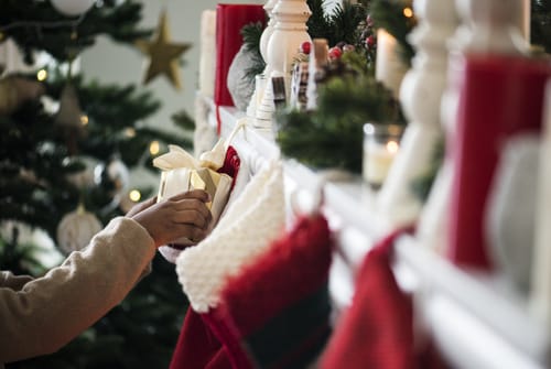a person pulls a gift from a stocking and thinks about holidays and the anniversary effect