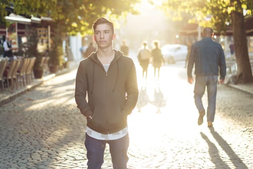 a man stands in the middle of a street and wonders do needle exchange programs work