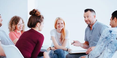 shutterstock_782629138 a group of people discuss the spiritual element of recovery