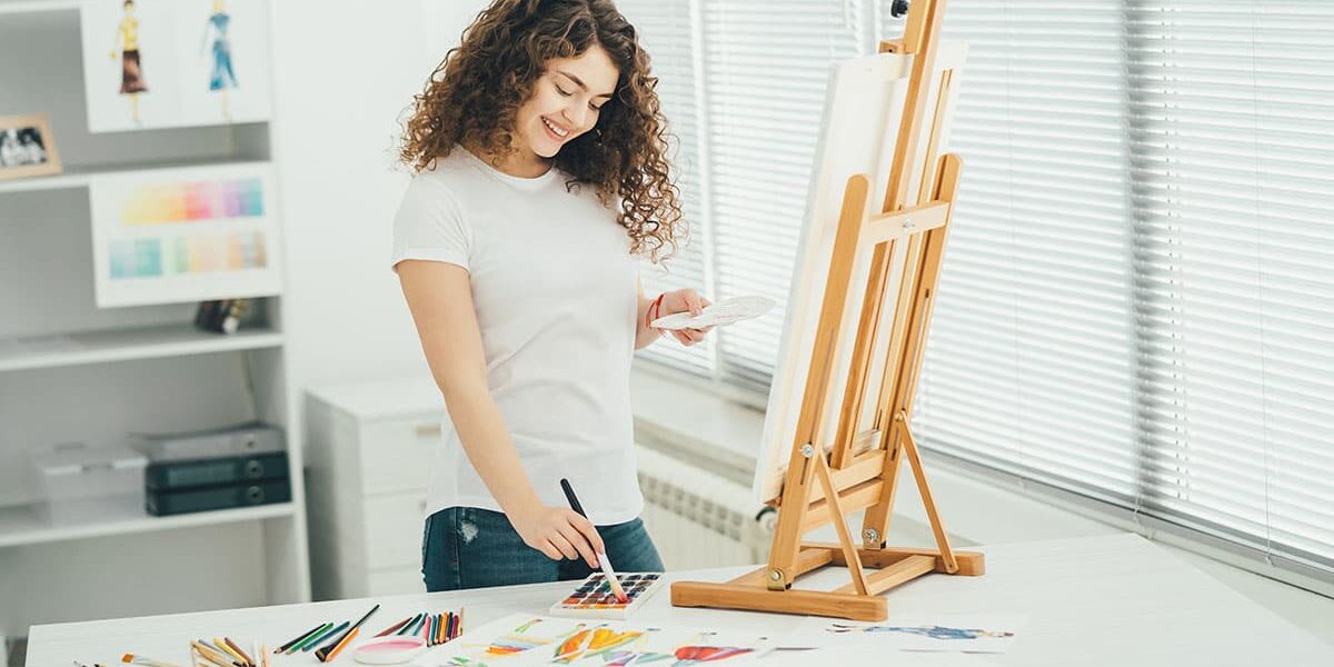 A woman paints, and wonders, "What is Recreation Therapy?"