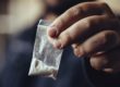 A man holds up a tiny baggie of cocaine and wonders about the difference between crack and cocaine