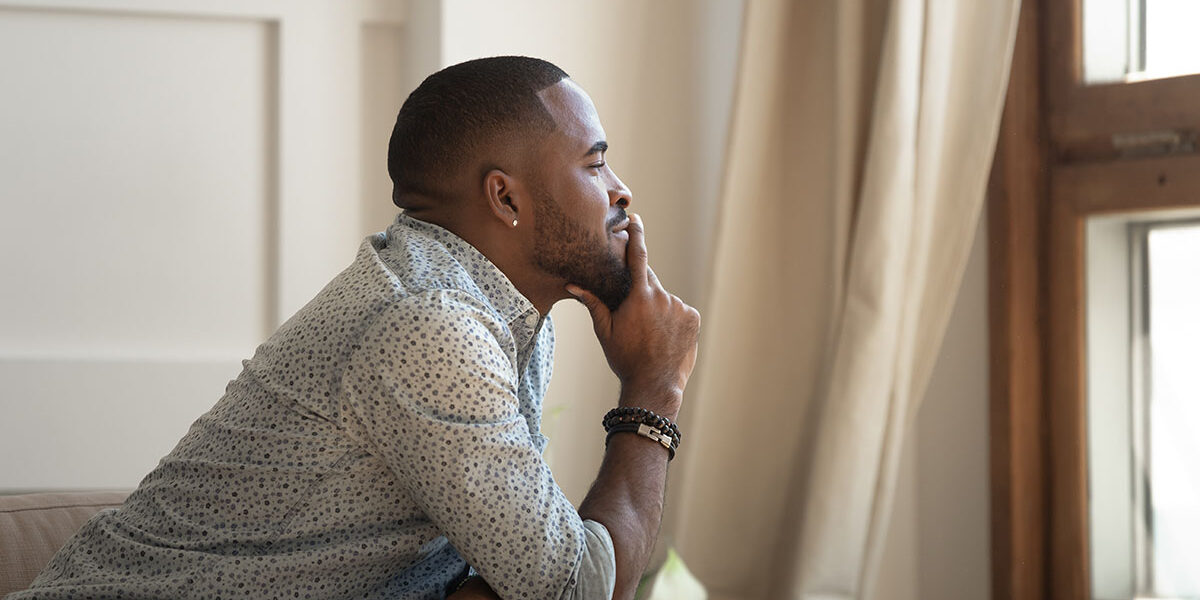 a man in quarantine thinking about his loved one in Depression Treatment