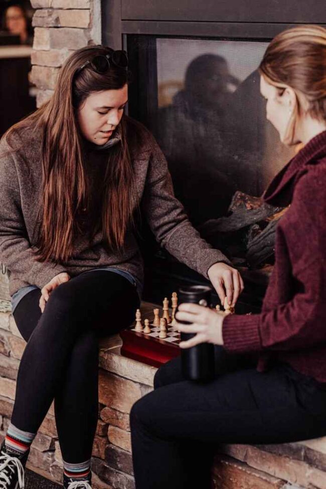 Two women playing chess together