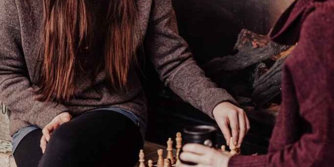 Two women playing chess together