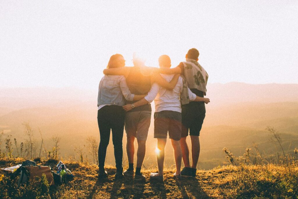 a family hugging each other at the top of a mountain
