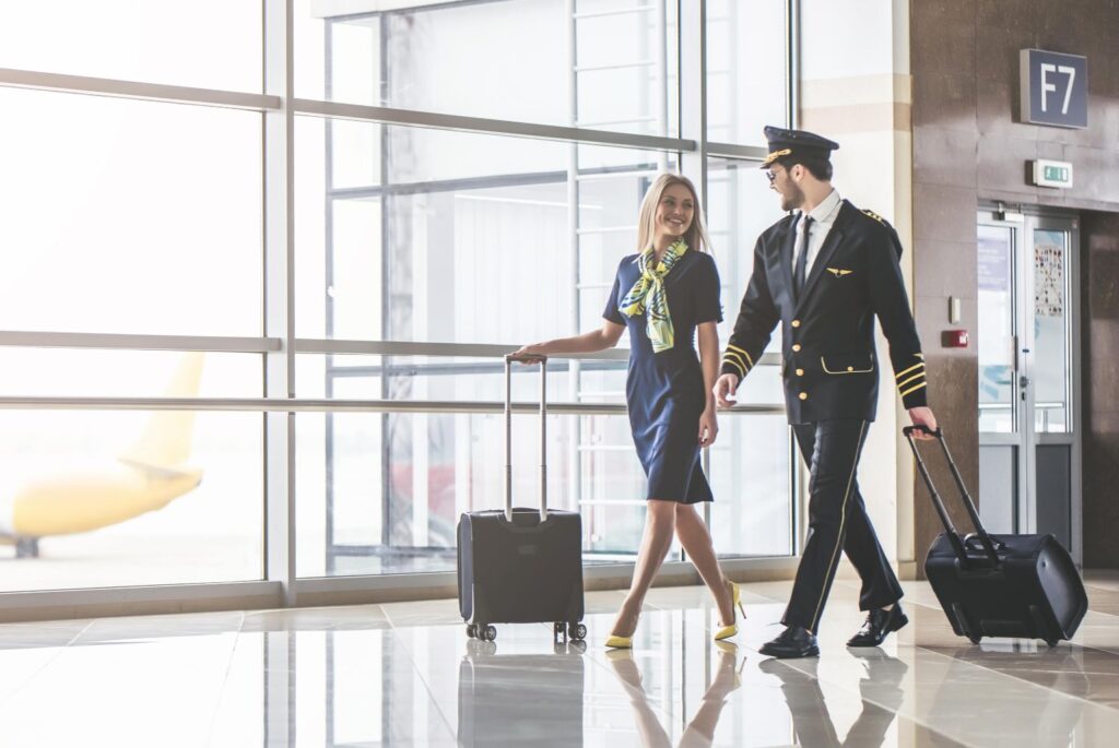 A flight attendant and a pilot walking through an airport