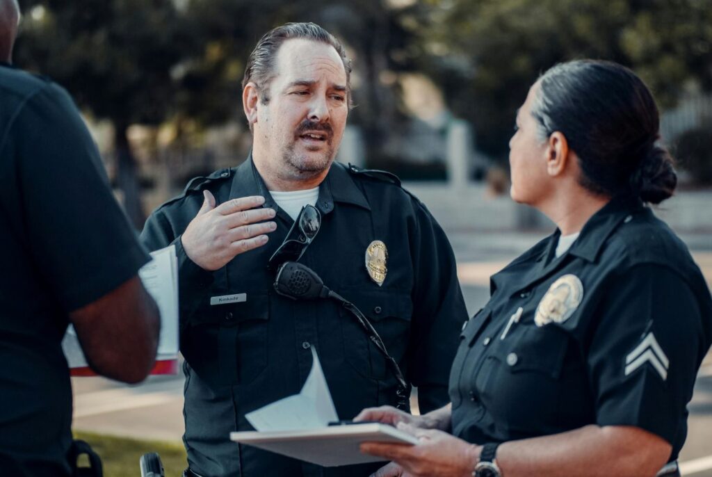 Two police officers in uniform talking to each other