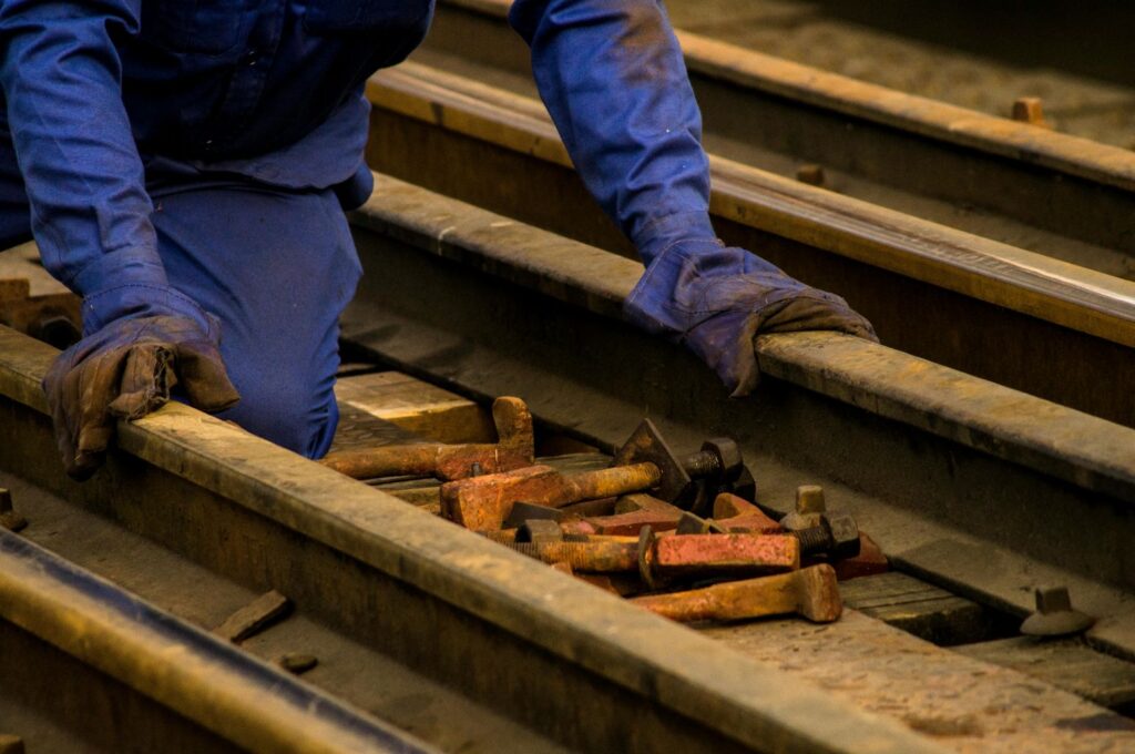 A railroad worker with a pile of tools