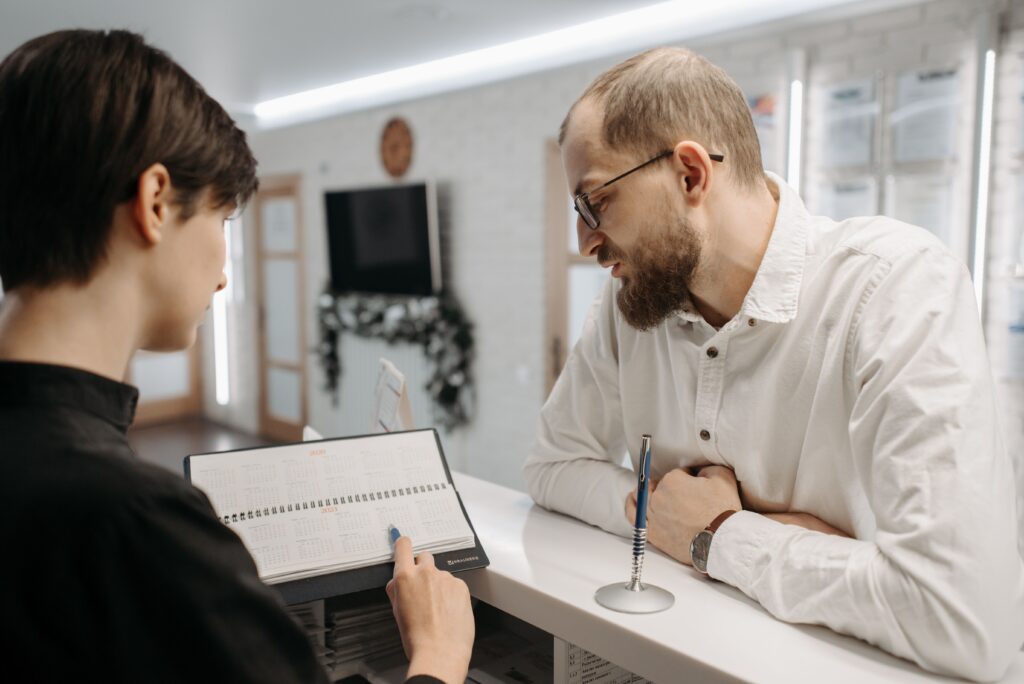 A man talking with a receptionist