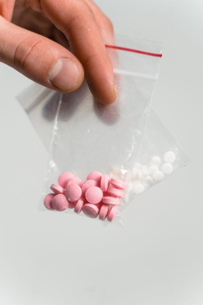 Two bags with colored pills