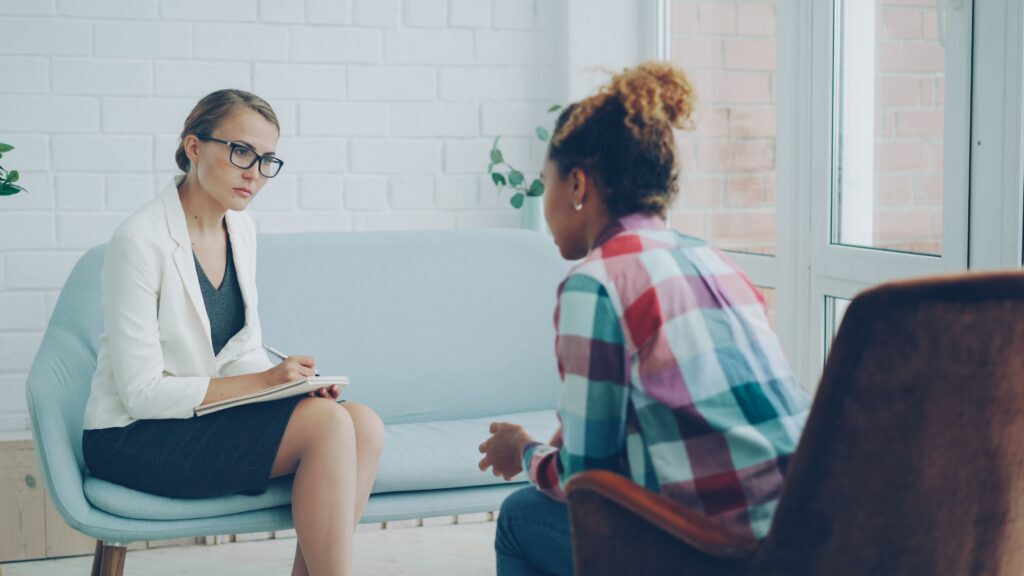 Female therapist talking with a female patient